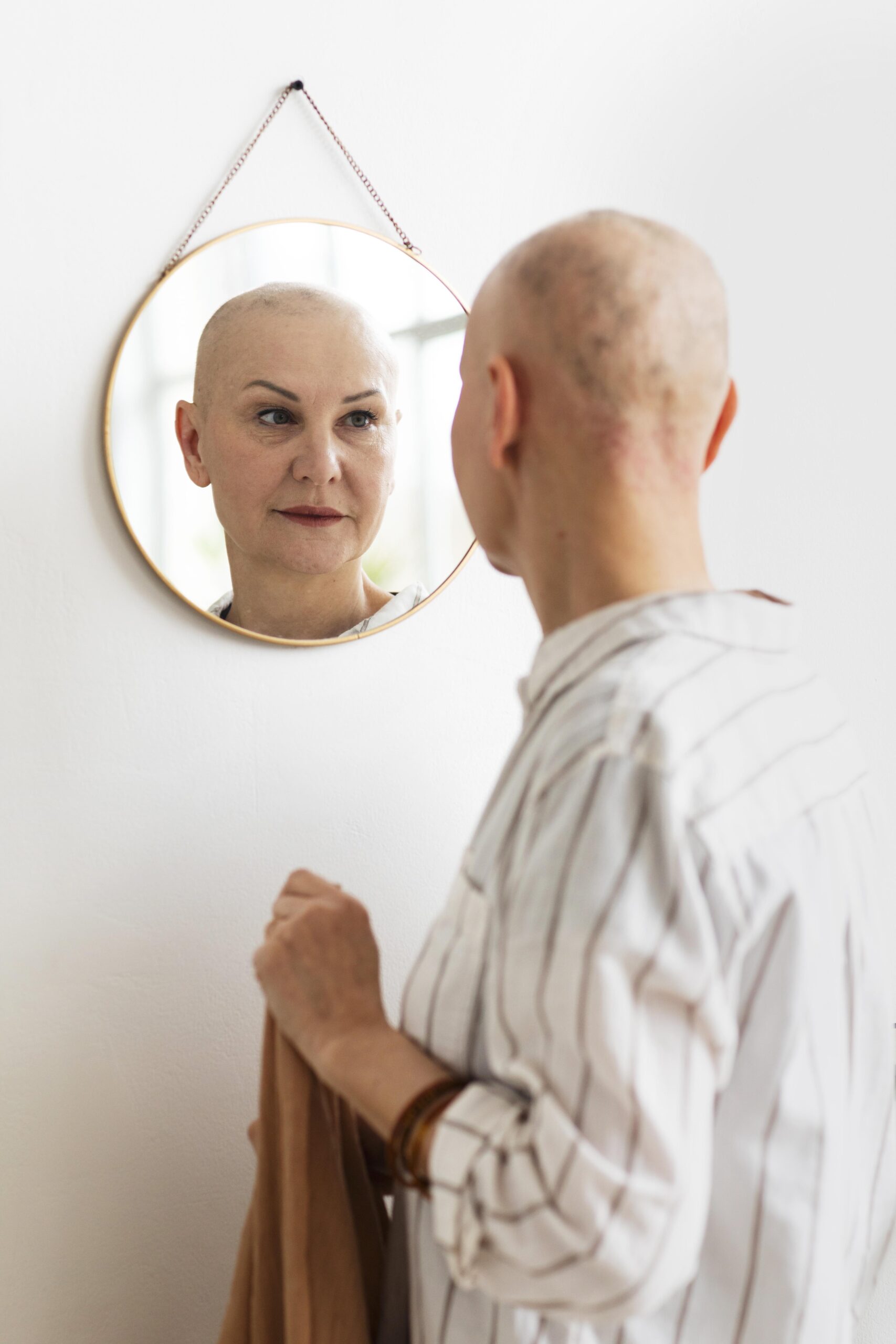 woman with skin cancer looking mirror